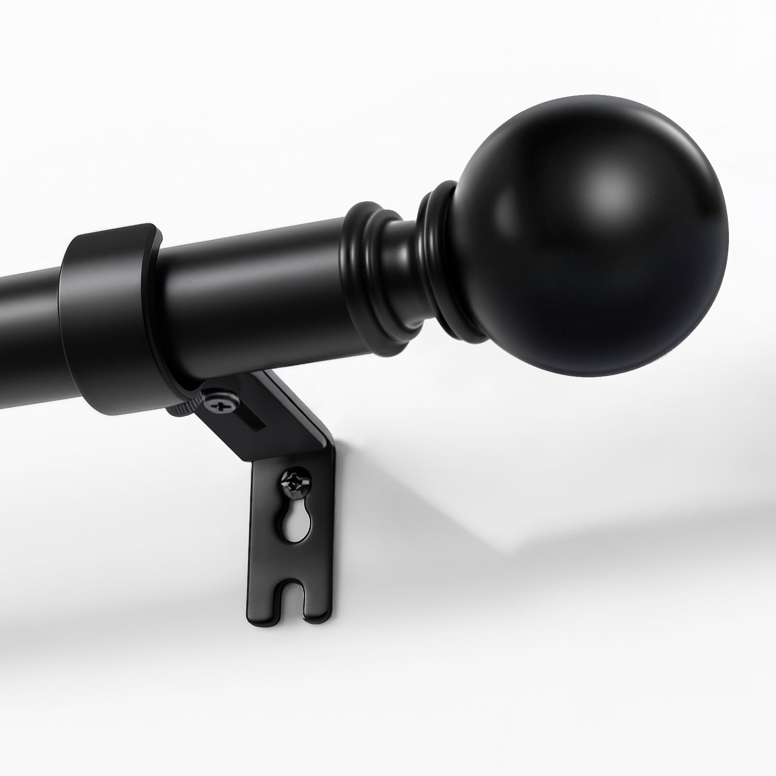Joydeco matte black adjustable curtain rod, 1-inch diameter, with spherical finial, mounted on a white wall.