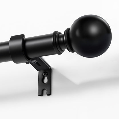 Joydeco matte black adjustable curtain rod, 1-inch diameter, with spherical finial, mounted on a white wall.