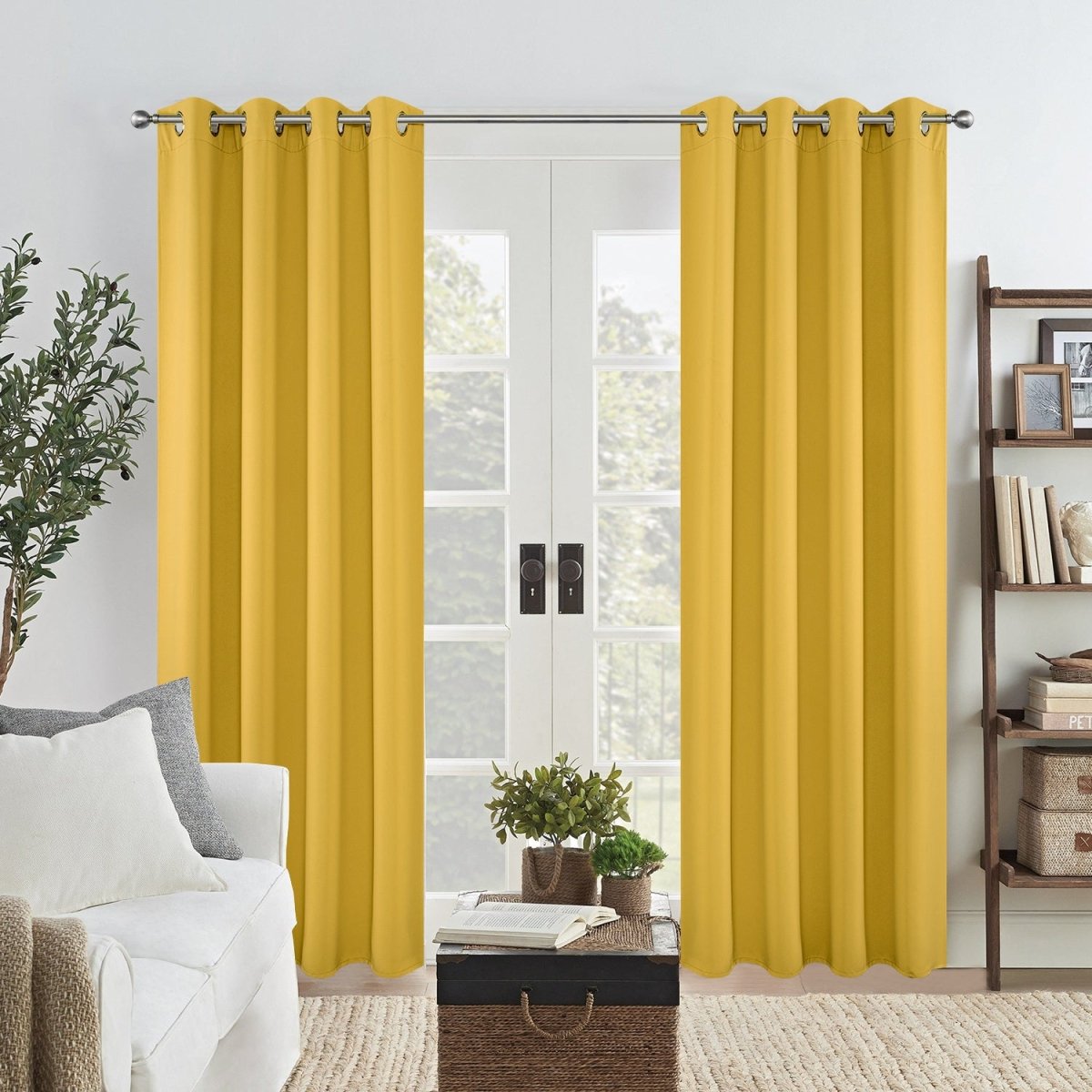 Joydeco yellow thermal insulated blackout curtains hanging on a silver rod in front of French doors.