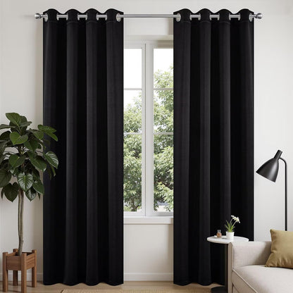 Joydeco black 108 inch blackout curtains with silver grommets, shown on a window with decor.