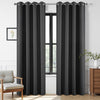 Two dark grey extra long blackout curtains with grommets on a rod in a living room setting.