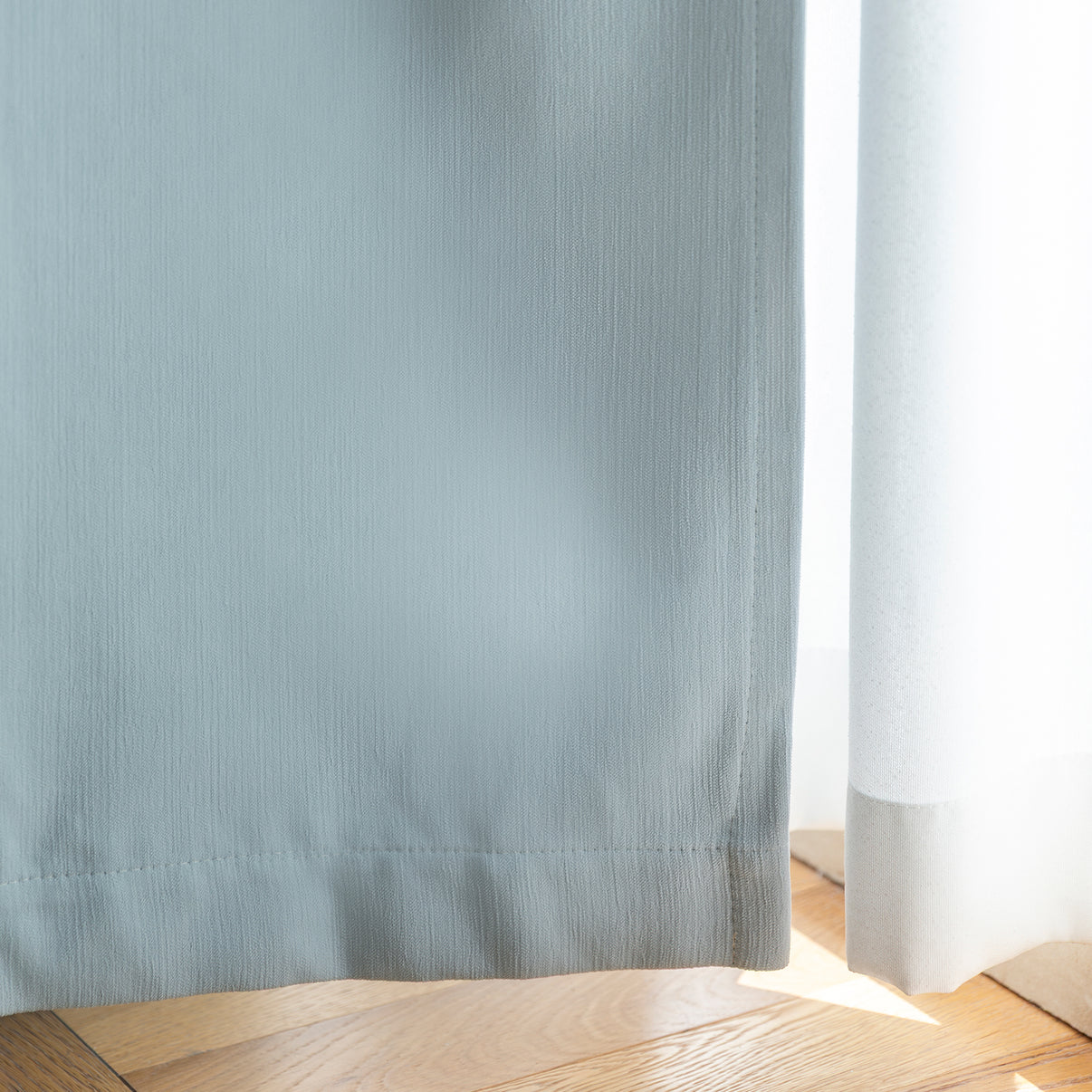 Close-up of Hayden custom blackout curtain fabric in soft blue-gray.