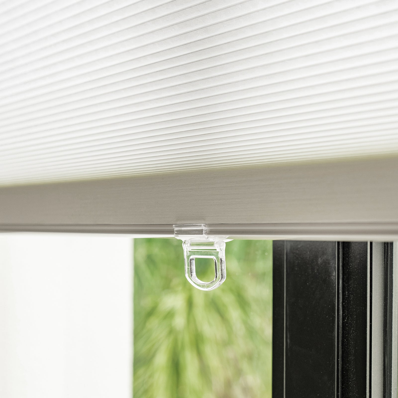 White Solace light filtering cellular shade, honeycomb fabric with pull tab.