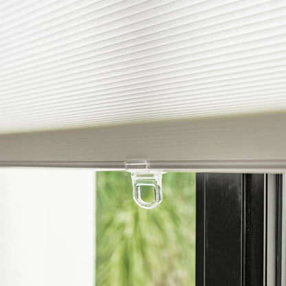 White Solace light filtering cellular shade, honeycomb fabric with pull tab.