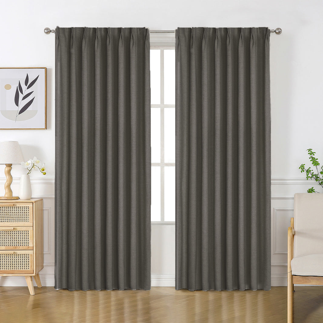 Charcoal gray Flaxaline linen blackout curtains draped on a rod, showcasing natural texture and privacy for a bedroom scene.