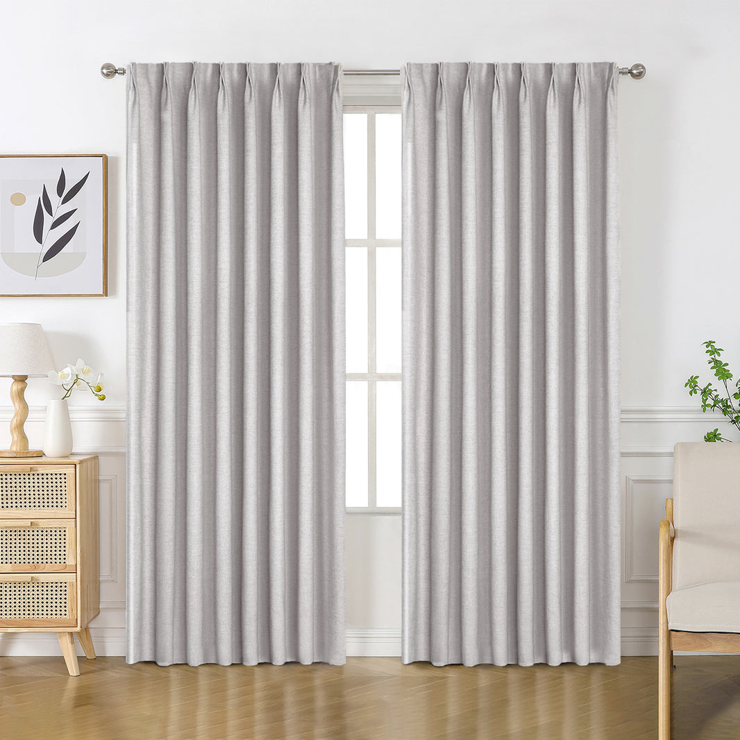 Light gray custom Flaxaline linen blackout curtains, pleated with natural texture, for light control.