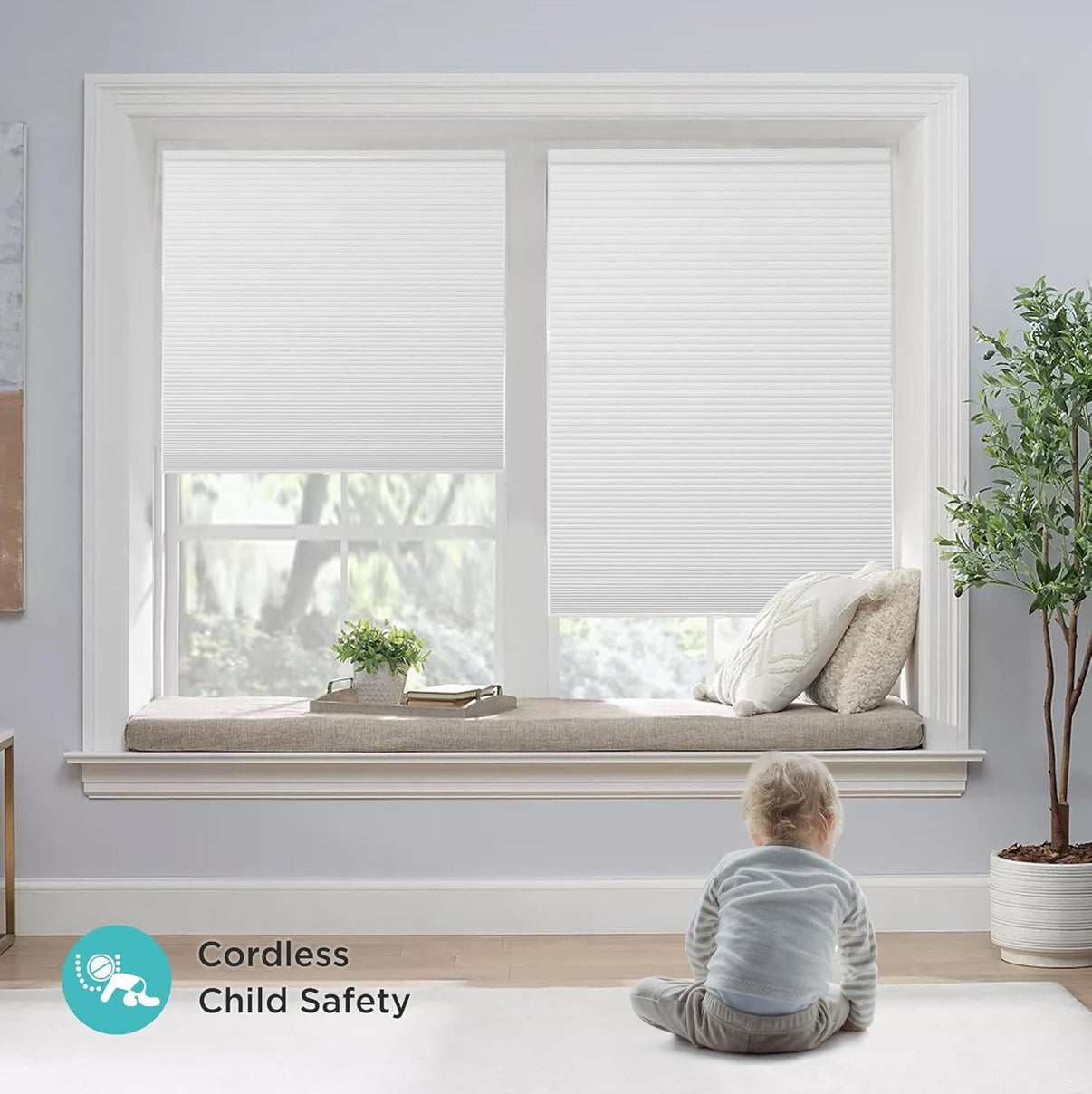 White cordless blackout cellular shades shown over a window, with a toddler nearby and a 'Cordless Child Safety' graphic.