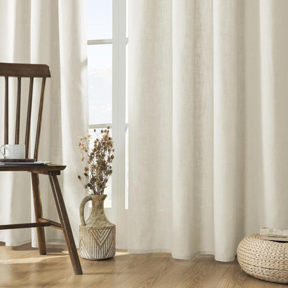 Ivory linen-blend light filtering curtains showcasing textured weave in a softly lit living room.