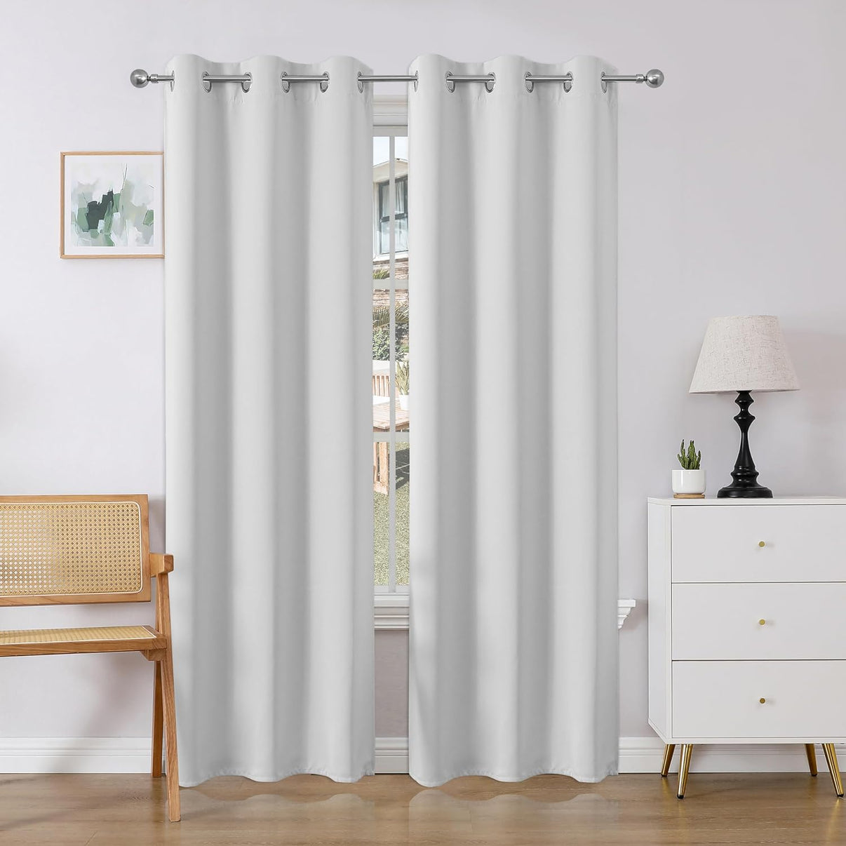 White Joydeco blackout curtains with silver grommets in a modern room setting.