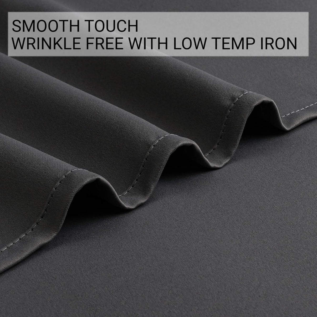 Grey blackout curtain fabric close-up showcasing smooth texture and wrinkle-free quality.