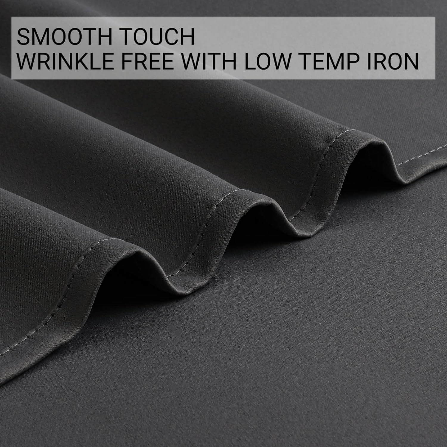 Grey blackout curtain fabric close-up showcasing smooth texture and wrinkle-free quality.