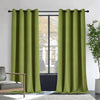 Joydeco moss green velvet blackout curtains, 2 panels with grommets, in a room with armchair and plant.