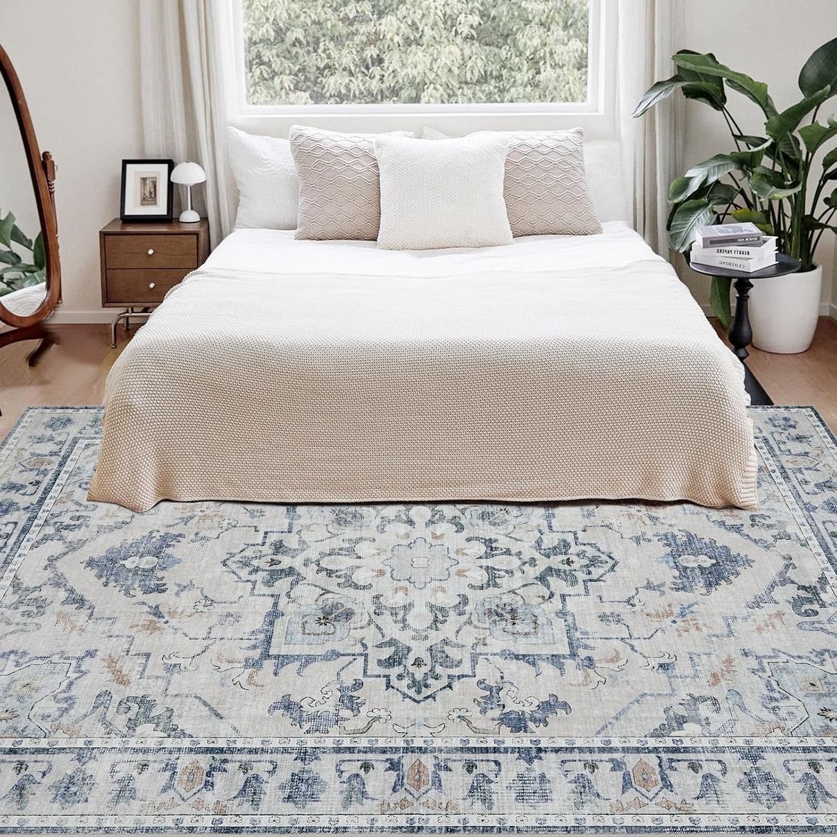 Joydeco 8x10 vintage floral area rug in blue and grey, shown in a bedroom with neutral decor.