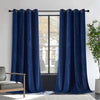 Two royal blue velvet blackout curtains with grommets on rod, framing window with house view. Includes armchair and plant.