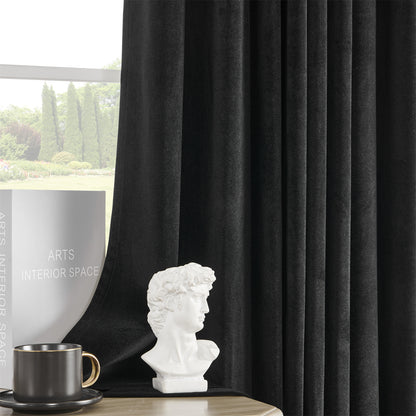 Joydeco black velvet blackout curtains, 84 inch length, plush texture, luxury sheen, in a styled room with decor.