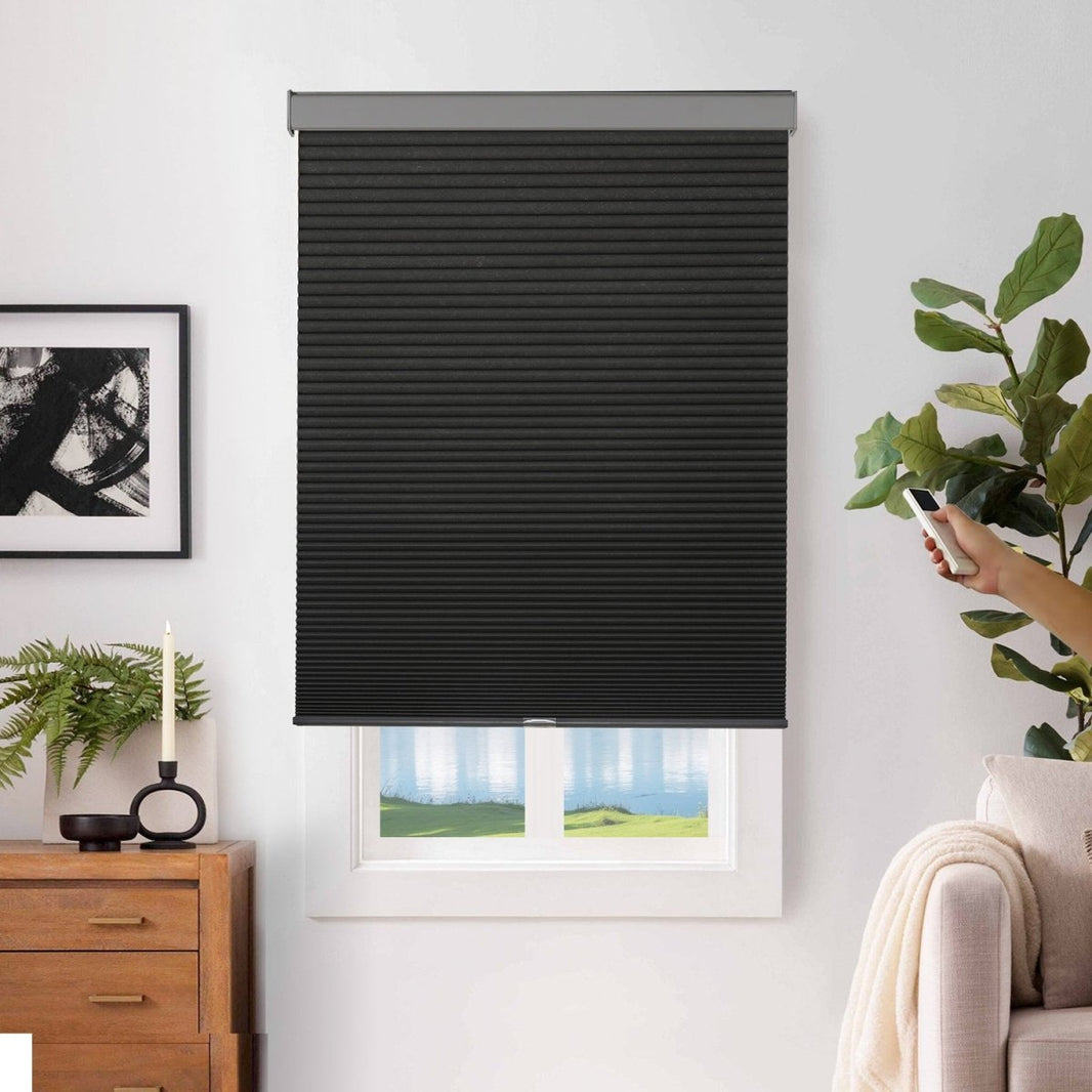 Joydeco black cordless cellular shades operated by remote control, with honeycomb texture, installed on a window.