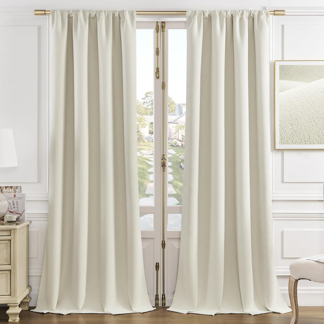Cream velvet blackout curtains with thermal insulation hanging from gold rods, framing French doors to a garden.
