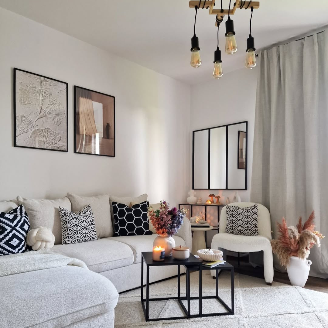 Joydeco light gray linen blackout curtains hung in a modern living room next to a cream sectional sofa.