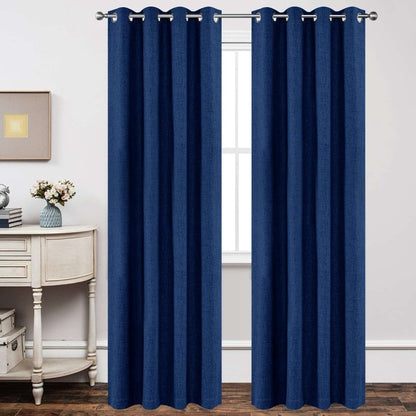 Navy blue linen blackout curtains with textured weave and grommet tops hanging on a silver rod in a room setting.