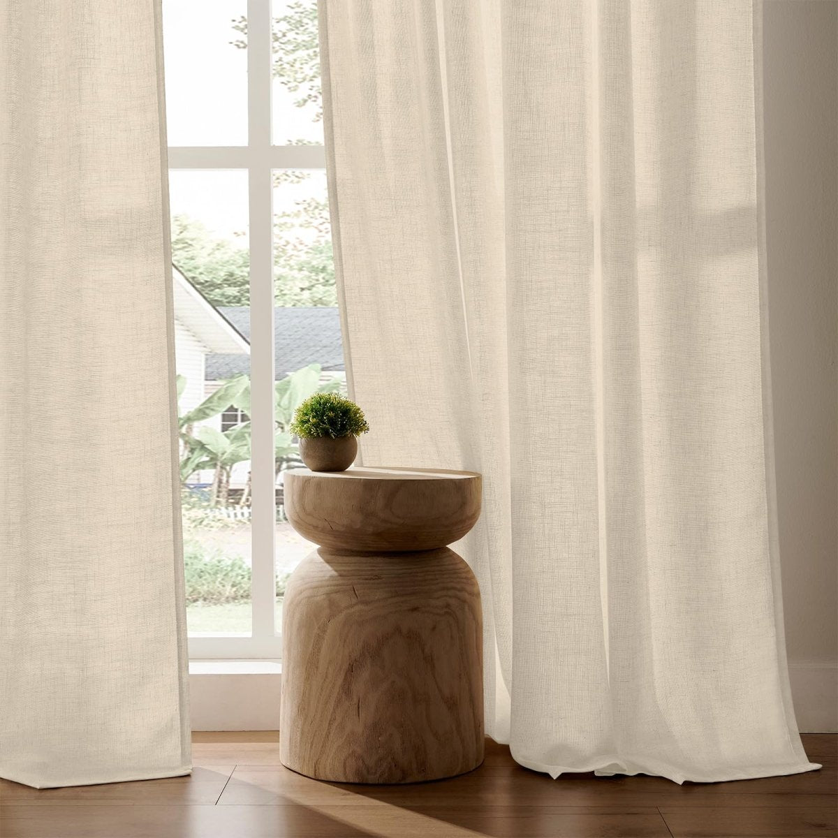 Joydeco light cream linen blend curtains, semi-sheer textured weave filtering light and providing privacy in a living room.