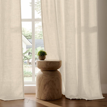 Joydeco light cream linen blend curtains, semi-sheer textured weave filtering light and providing privacy in a living room.