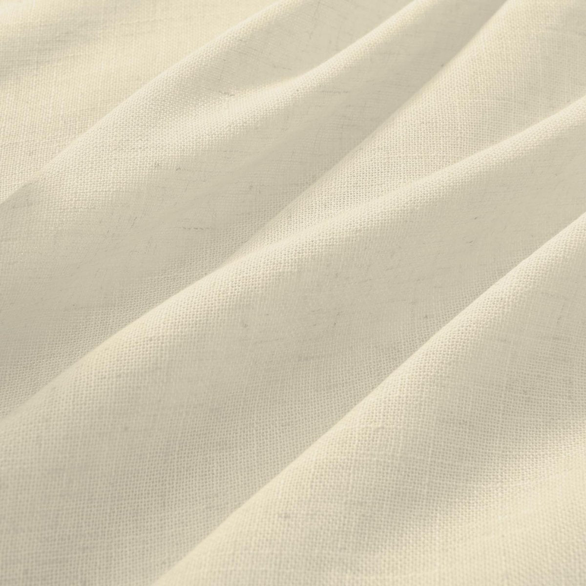 Close-up of ivory linen fabric texture, ideal for light filtering curtains, showing natural slubs and elegant drape.