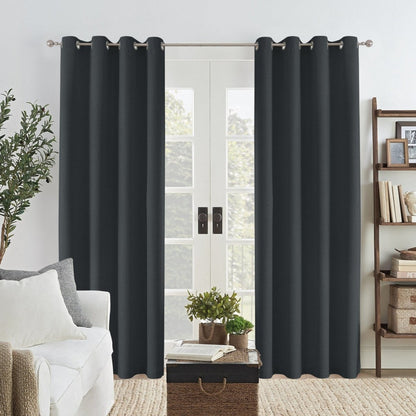 Charcoal grey linen blackout curtains with silver grommets over French doors in a living room.