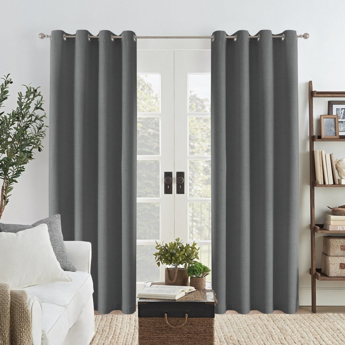 Dark grey Joydeco custom linen blackout curtains with grommets framing double doors in a living room.
