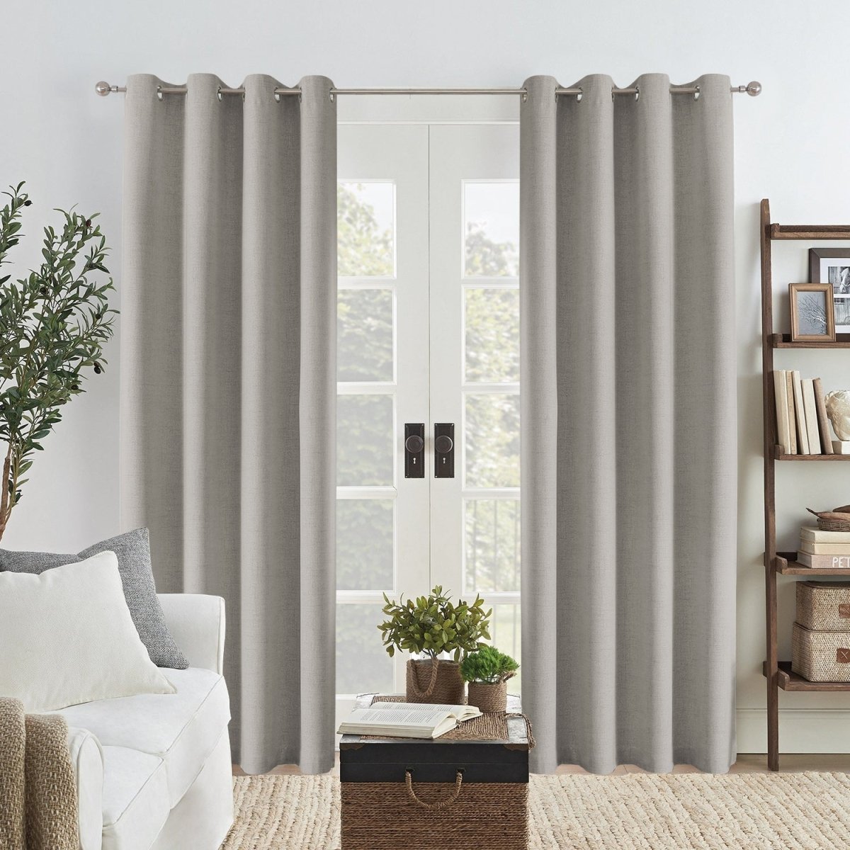 Joydeco Grey Linen Blackout Curtains with grommets framing a glass door in a modern living room.
