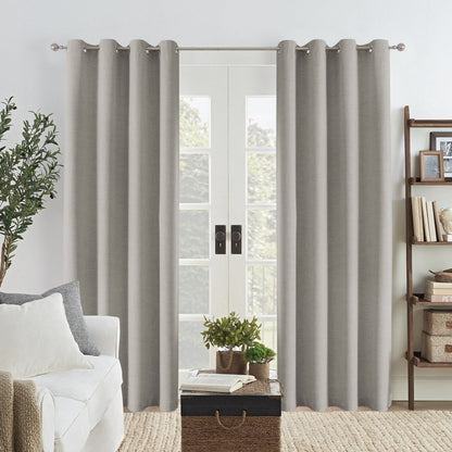 Joydeco Grey Linen Blackout Curtains with grommets framing a glass door in a modern living room.