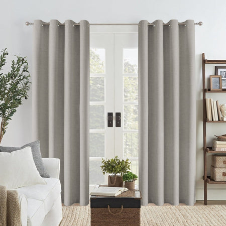 Joydeco Grey Linen Blackout Curtains with grommets framing a glass door in a modern living room.