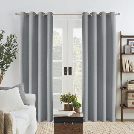 Light grey Joydeco linen blackout curtains with grommets hanging on a double door, adding texture to a living room.