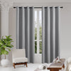Two light gray Joydeco 100% blackout curtains with faux linen texture and grommet tops.