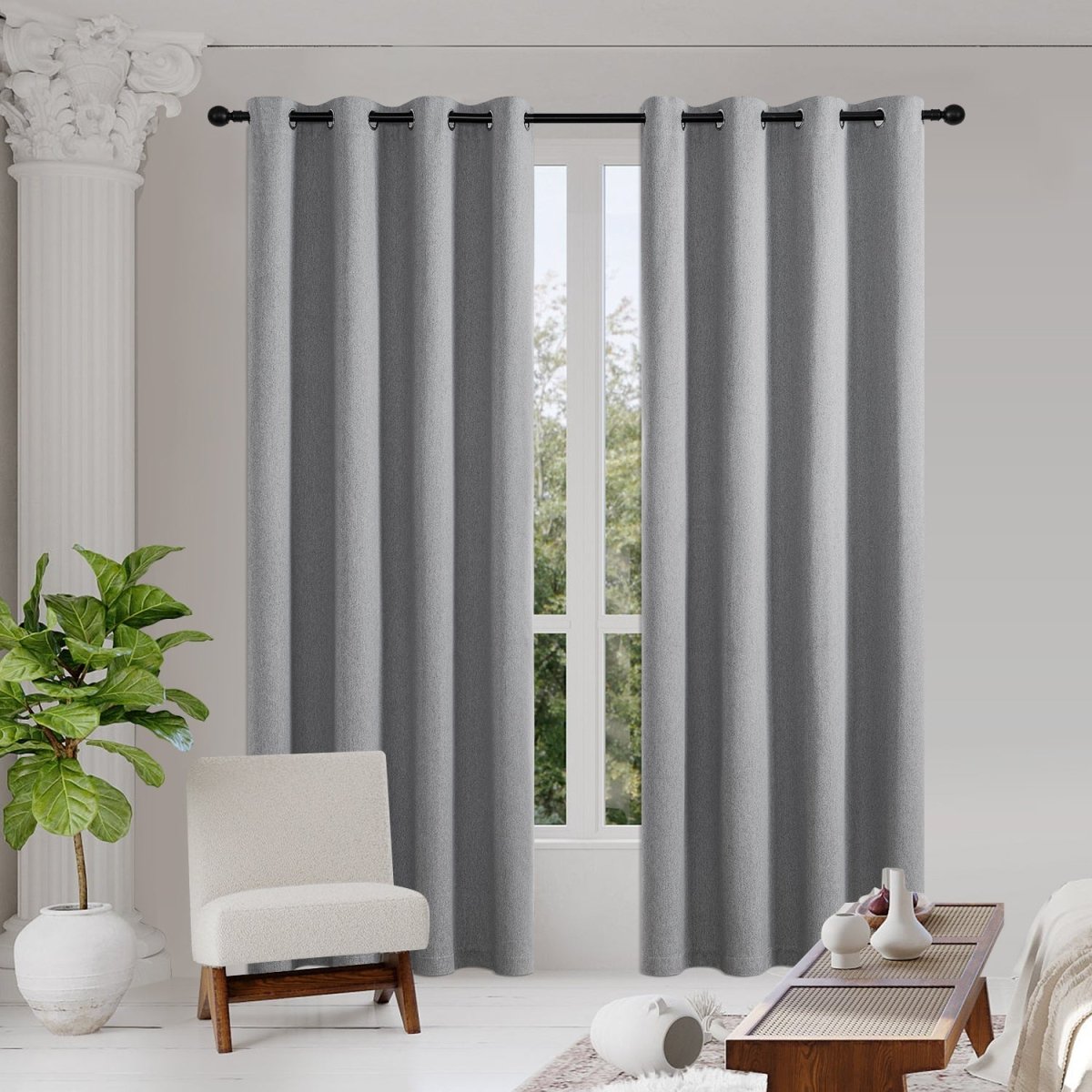 Two light gray Joydeco 100% blackout curtains with faux linen texture and grommet tops.