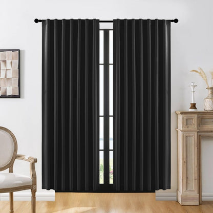 Black faux linen blackout curtains with subtle texture hung on a window, offering room darkening and style.
