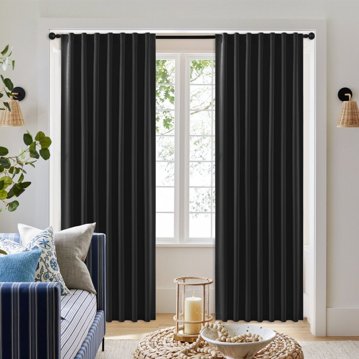 Joydeco black faux linen 100% blackout thermal insulated curtains hung on a window, showcasing room darkening and style.