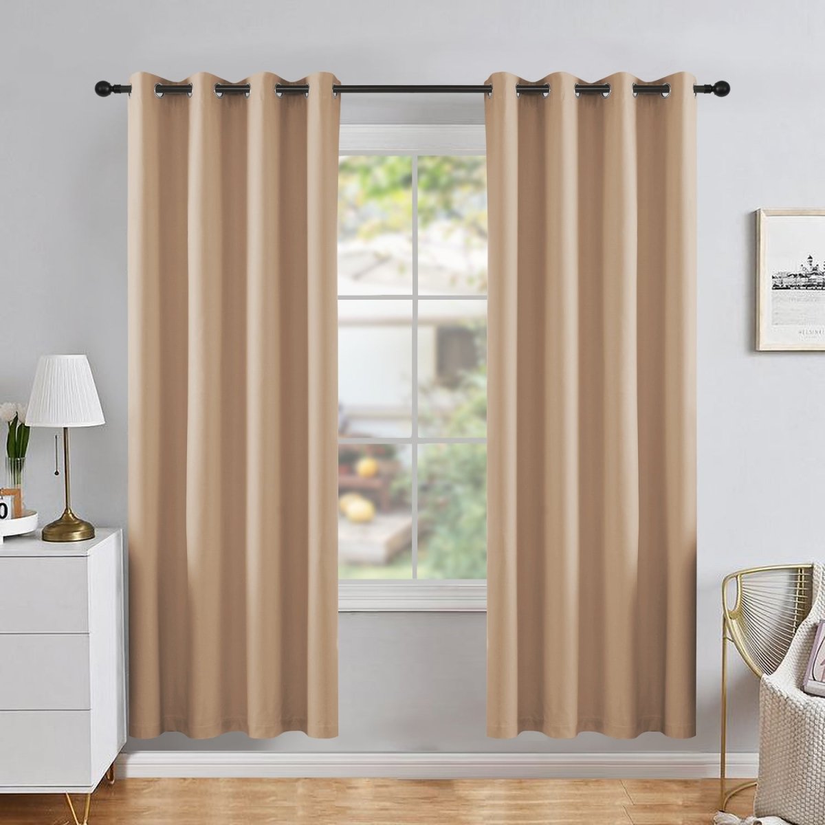 Joydeco beige blackout curtains, two thermal insulated panels hanging in a room with a white dresser and gold accent chair.