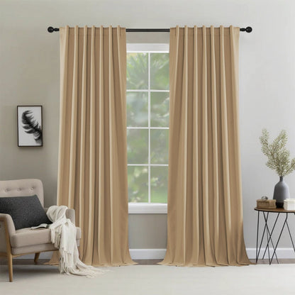Two dark beige Joydeco thermal insulated blackout curtain panels hanging from a grommet rod in a modern living room.