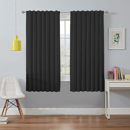 Two Joydeco black faux linen blackout curtains in a bedroom setting, providing room darkening and thermal insulation.