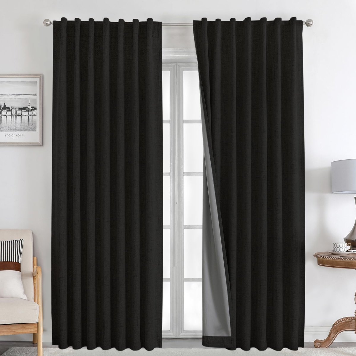 Joydeco black 100% blackout linen curtains with grommet tops, thermal insulated, on a silver rod in a bedroom setting.