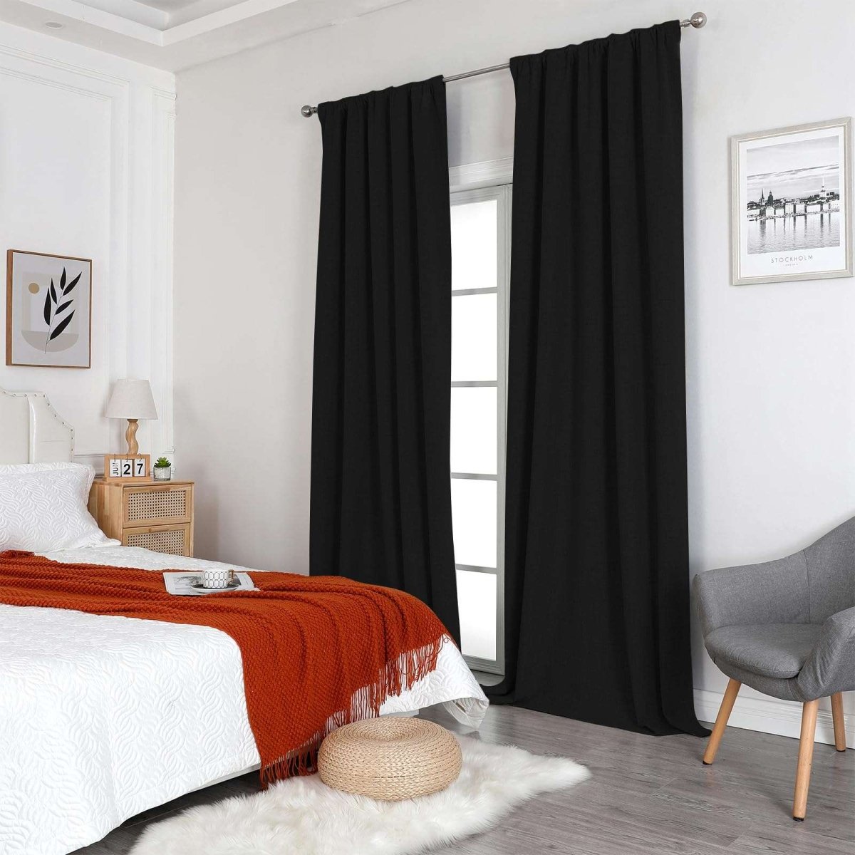 Joydeco black 100% blackout linen curtains in a bedroom, thermal insulated, with grommet tops, on silver rod.