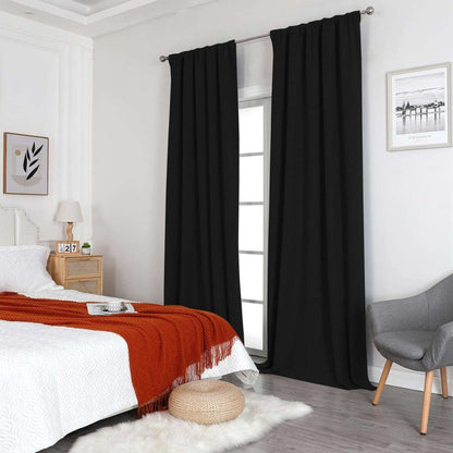 Joydeco black 100% blackout linen curtains in a bedroom, thermal insulated, with grommet tops, on silver rod.