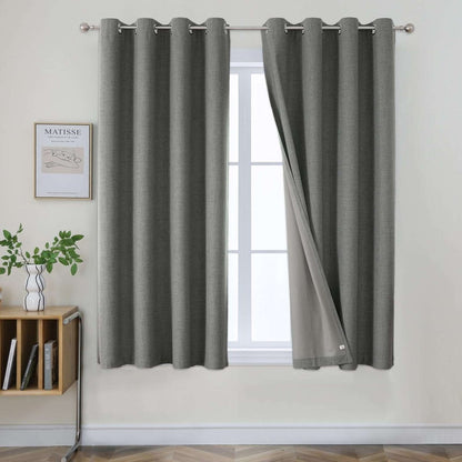 Two grey linen blackout curtains with grommets, one panel partially open revealing a lighter lining.