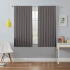 Two grey 100% blackout curtains hang on a silver rod, ideal for bedroom or living room light blocking and privacy.