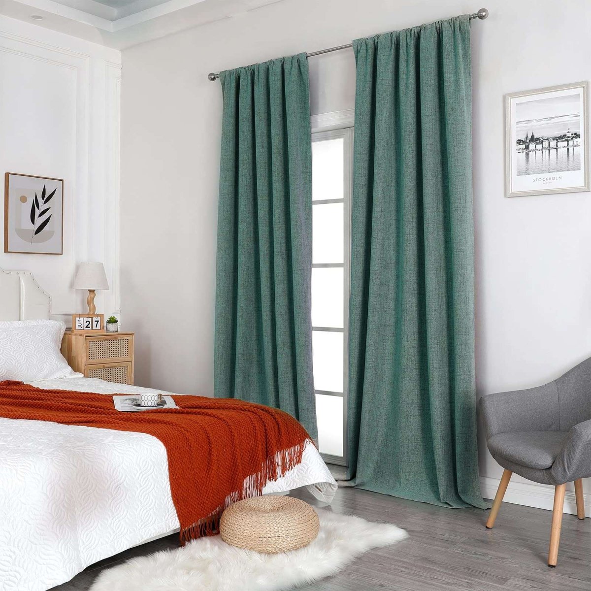 Hunter green linen blackout curtains with thermal insulation shown in a bedroom on a silver rod.