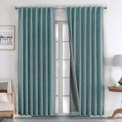 Hunter green textured linen blackout curtains with thermal lining and silver grommets, shown in a living room.