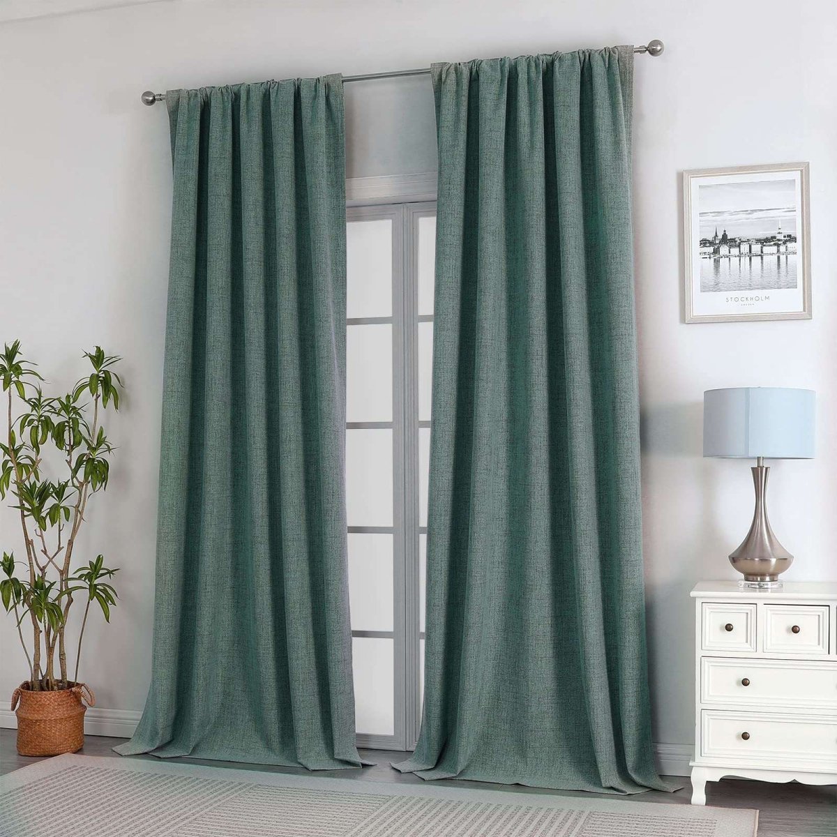 Hunter green linen blackout curtains in a room, offering thermal insulation and noise reduction.
