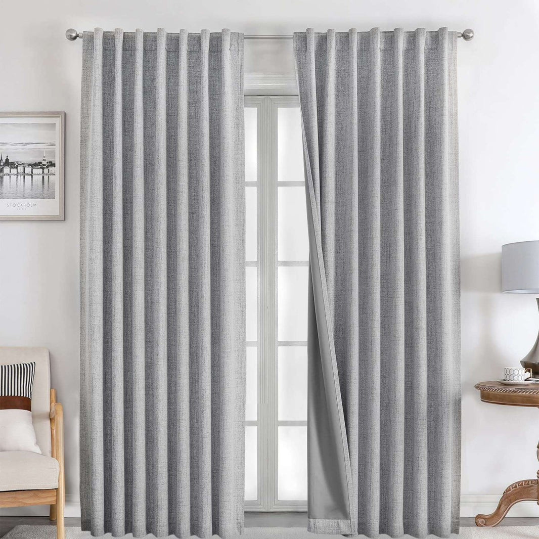 Joydeco light grey linen blackout curtains with dark lining, rod pocket/back tab hanging on silver rod.