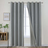Two light grey textured linen blackout curtain panels with metal grommets displayed on a silver rod.