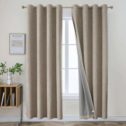 Two beige faux linen blackout curtains with grommet tops hanging on a rod, one panel slightly open to show grey liner.